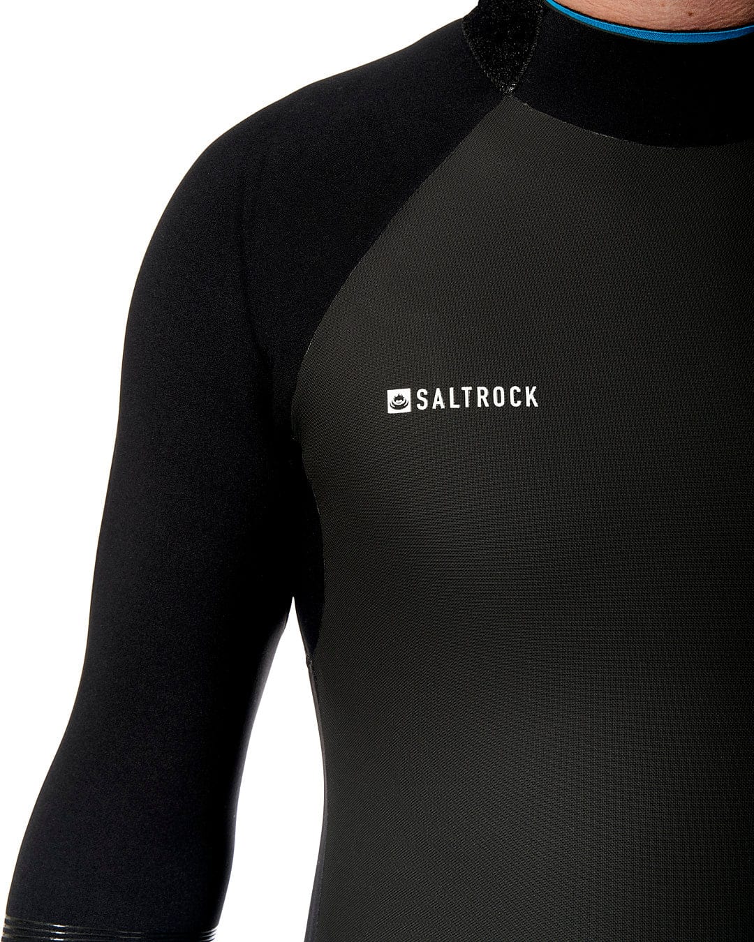 A man wearing a Synthesis - Mens 4/3 Back Zip Full Wetsuit - Black with the brand Saltrock on it.