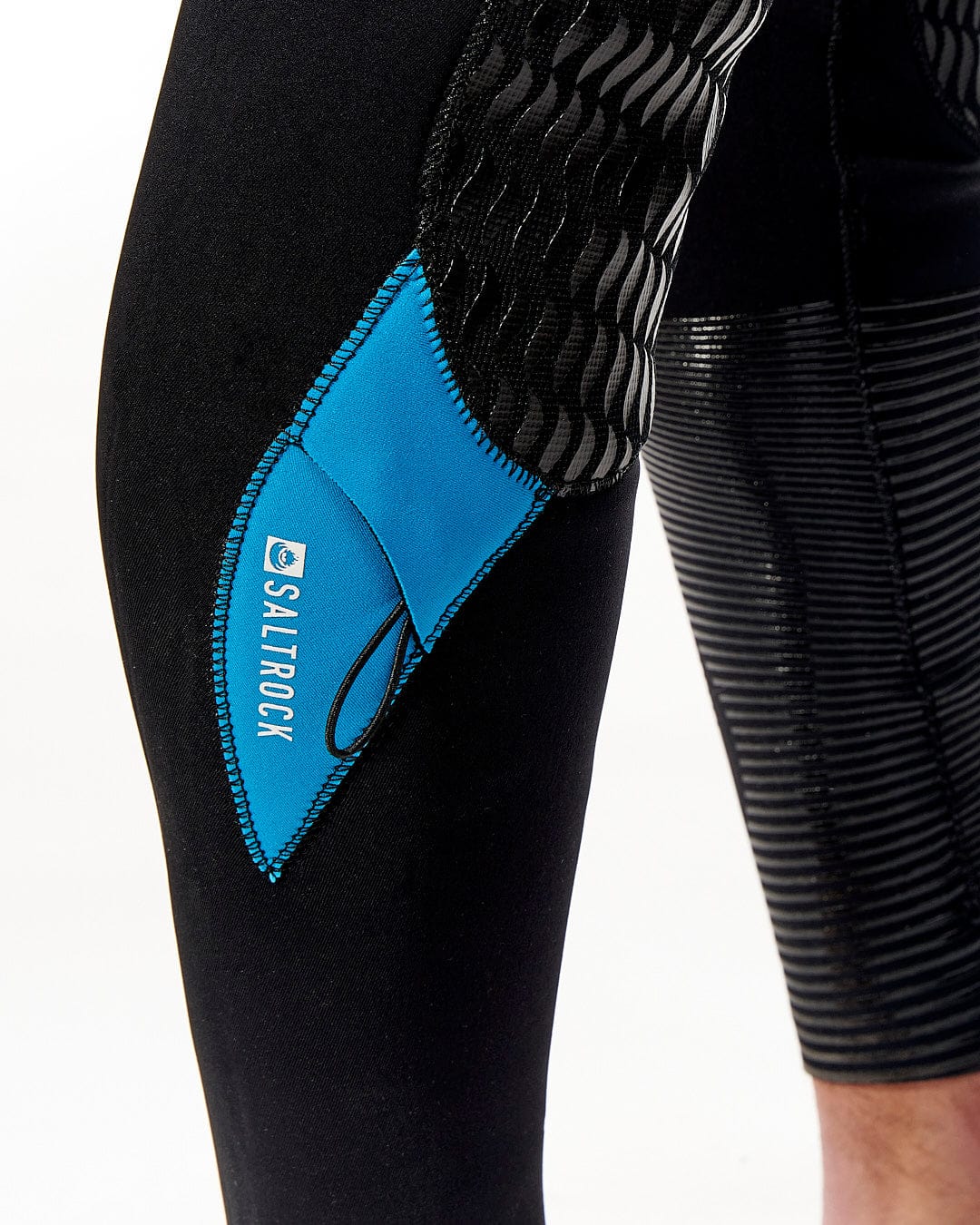 The leg of a man wearing a Saltrock Synthesis - Mens 4/3 Back Zip Full Wetsuit - Black.