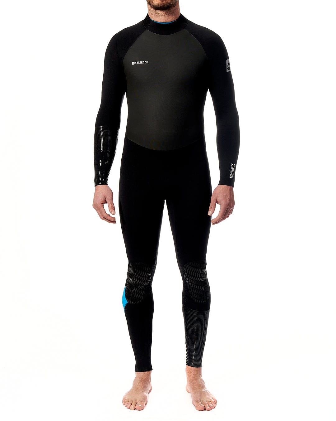 A man in a Saltrock Synthesis - Mens 4/3 Back Zip Full Wetsuit - Black standing on a white background.