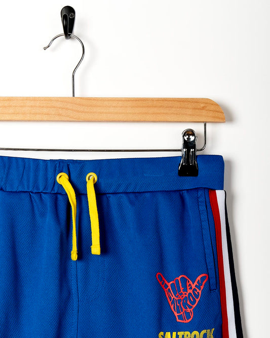 A Saltrock Team - Kids Tech Shorts - Blue jogging short with a red, yellow and blue stripe.