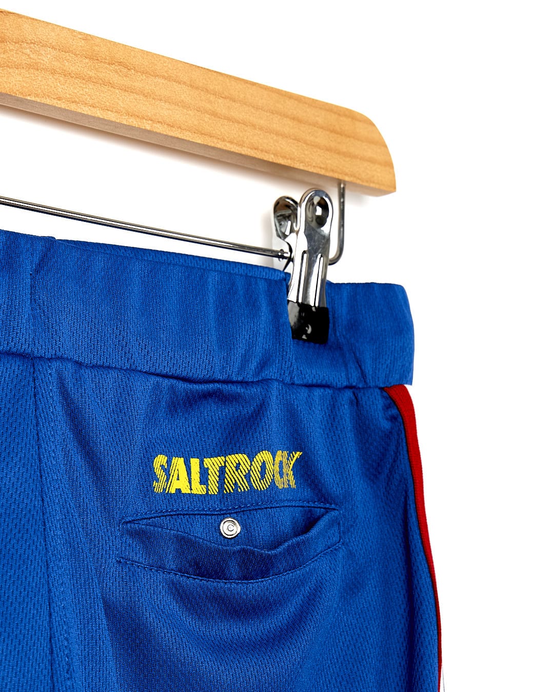 A pair of Team - Kids Tech Shorts - Blue with the word Saltrock on them.