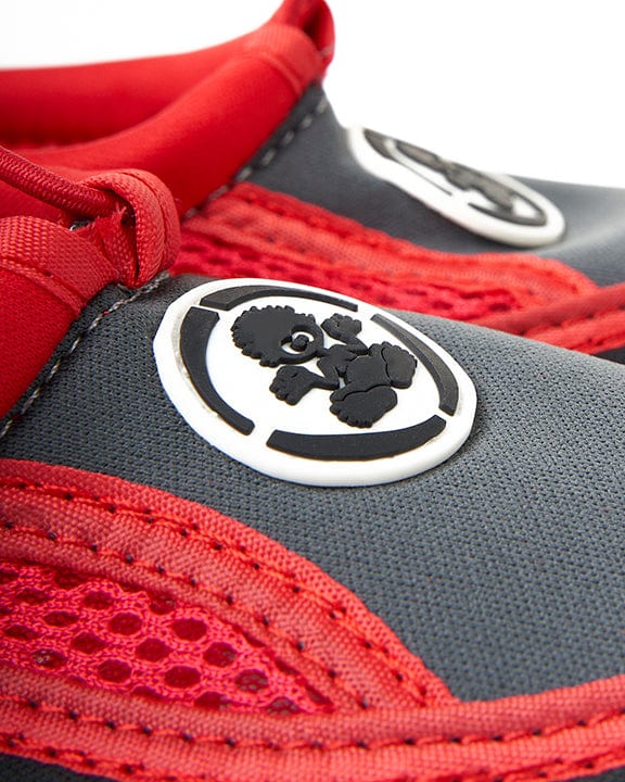 A close up of a Tok - Kids Aqua Shoes - Red shoe with a Saltrock logo on it.