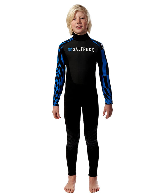 A young boy in a Saltrock - Kids 3/2 Full Wetsuit - Black standing on a white background.