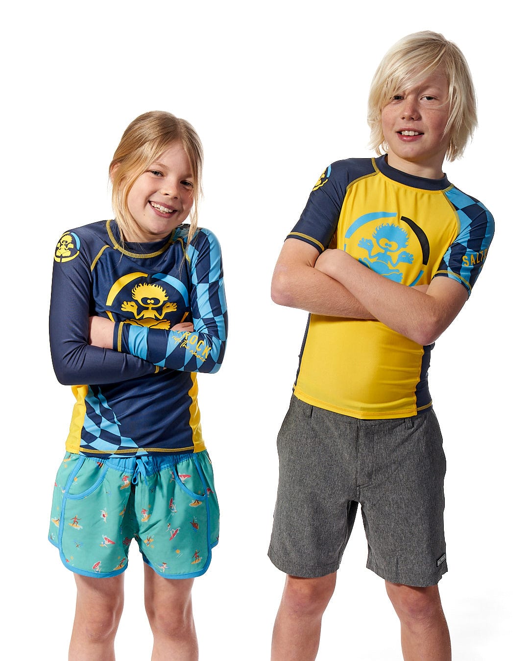 Two children posing for a photo in a Saltrock Warp - Kids Short Sleeve Rashvest - Yellow, exuding both warmth and comfort.