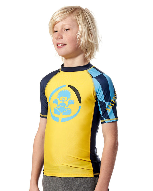 a young boy wearing a Saltrock Warp - Kids Short Sleeve Rashvest - Yellow.