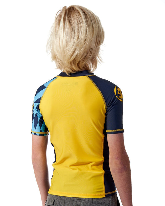 The back of a young boy wearing a Saltrock Warp - Kids Short Sleeve Rashvest - Yellow.
