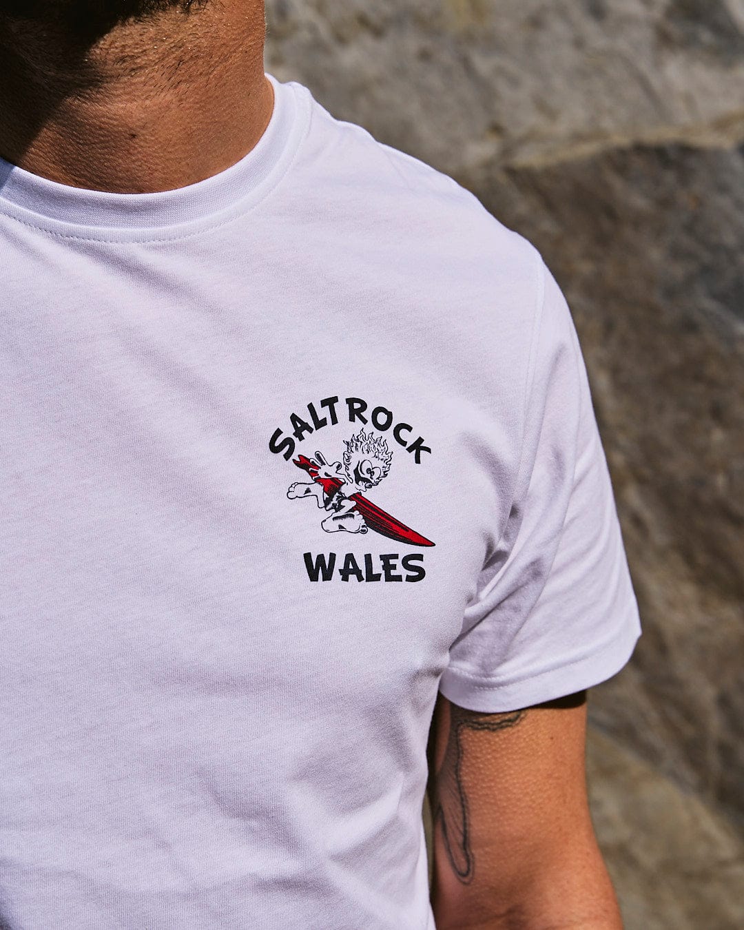 A man wearing a Saltrock Wave Rider Wales - Mens Short Sleeve T-Shirt in White.