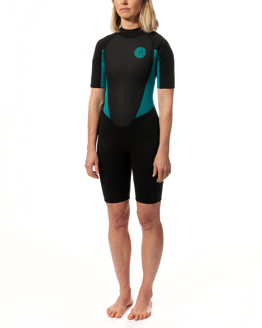 A woman in a Saltrock Core - Womens 3/2 Shortie Wetsuit - Black/Turquoise.