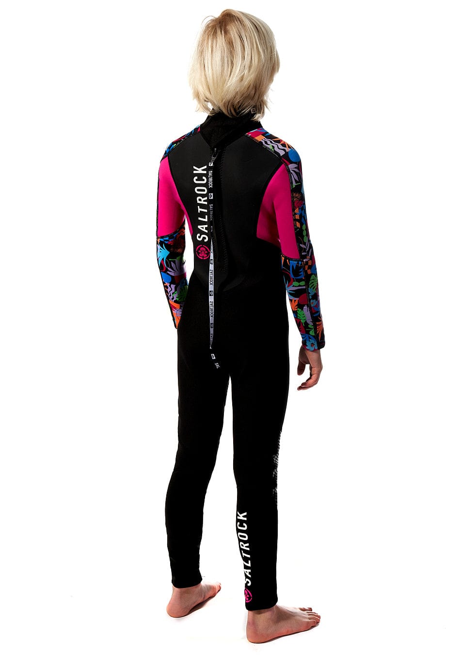 A girl wearing a Saltrock Zephyr - Kids 3/2 Full Wetsuit - Black and pink.
