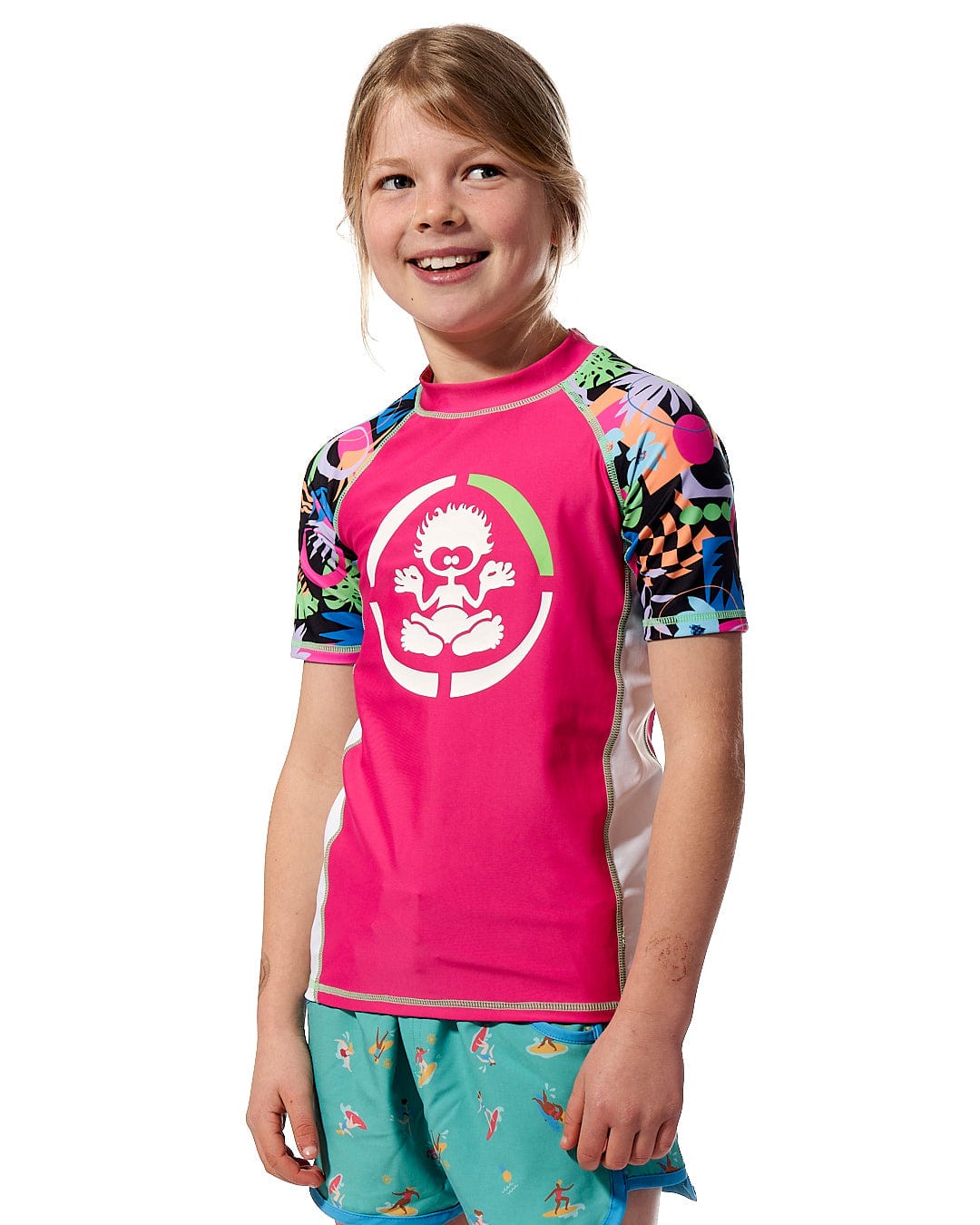 A girl wearing a Zephyr - Kids UPF 50+ Short Sleeve Rashvest in Pink by Saltrock for sun protection.