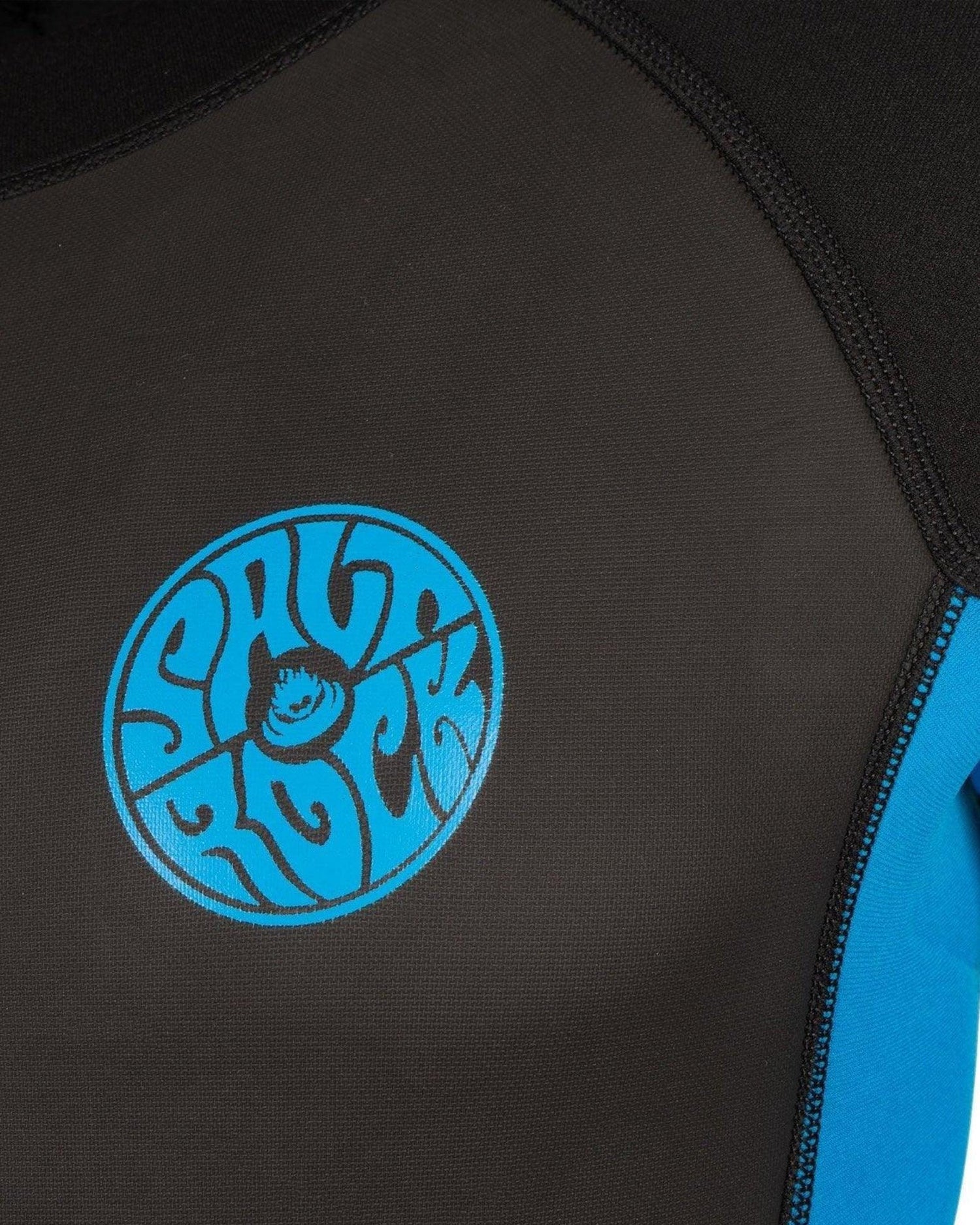 Close-up of a Saltrock Core - Men's 3/2 Shortie Wetsuit in Black/Blue with a circular blue logo featuring intricate white designs.